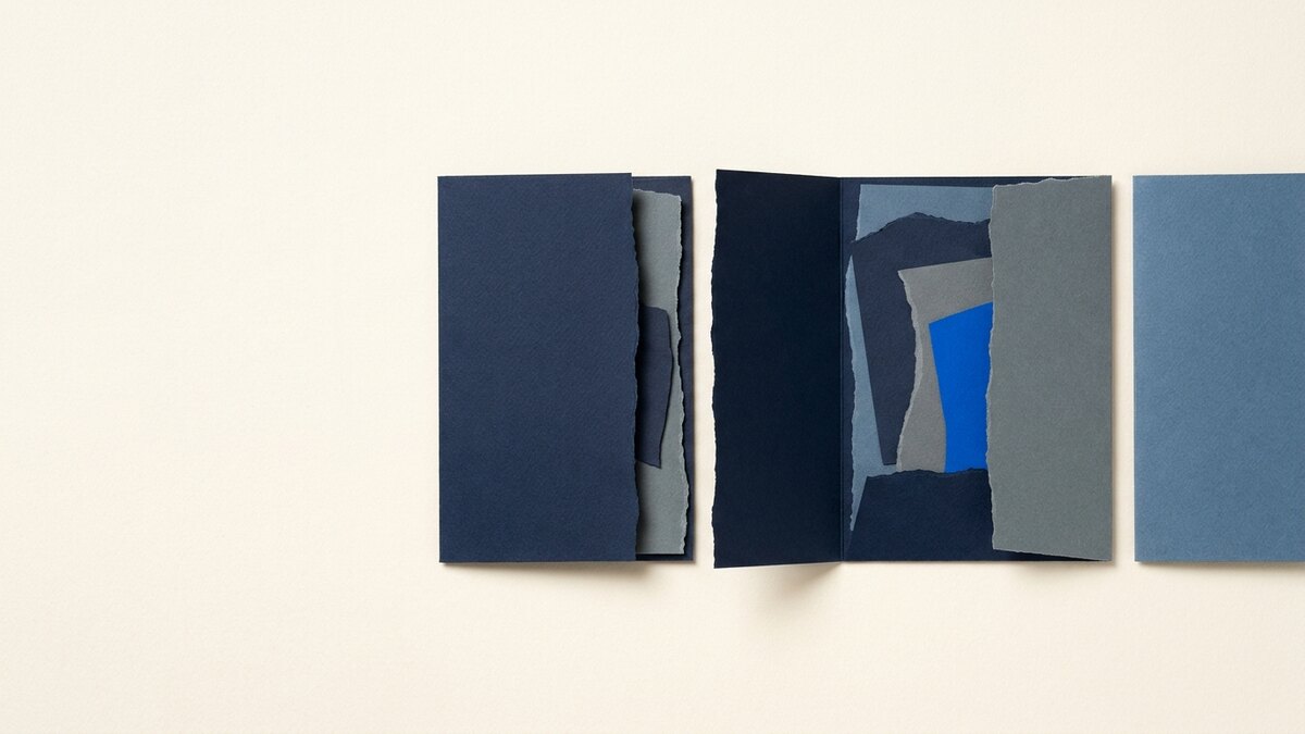 Paper-collage illustration of dark blue folders opened side by side, revealing layered torn-paper shapes inside, representing comparing web design companies
