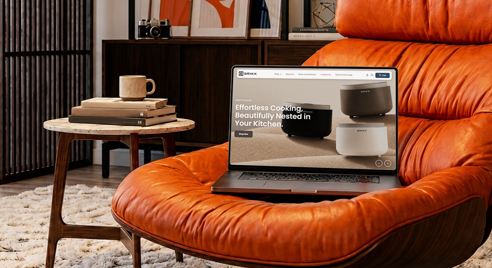 A designer's desk with a laptop showing a website wireframe, color swatches and a notebook